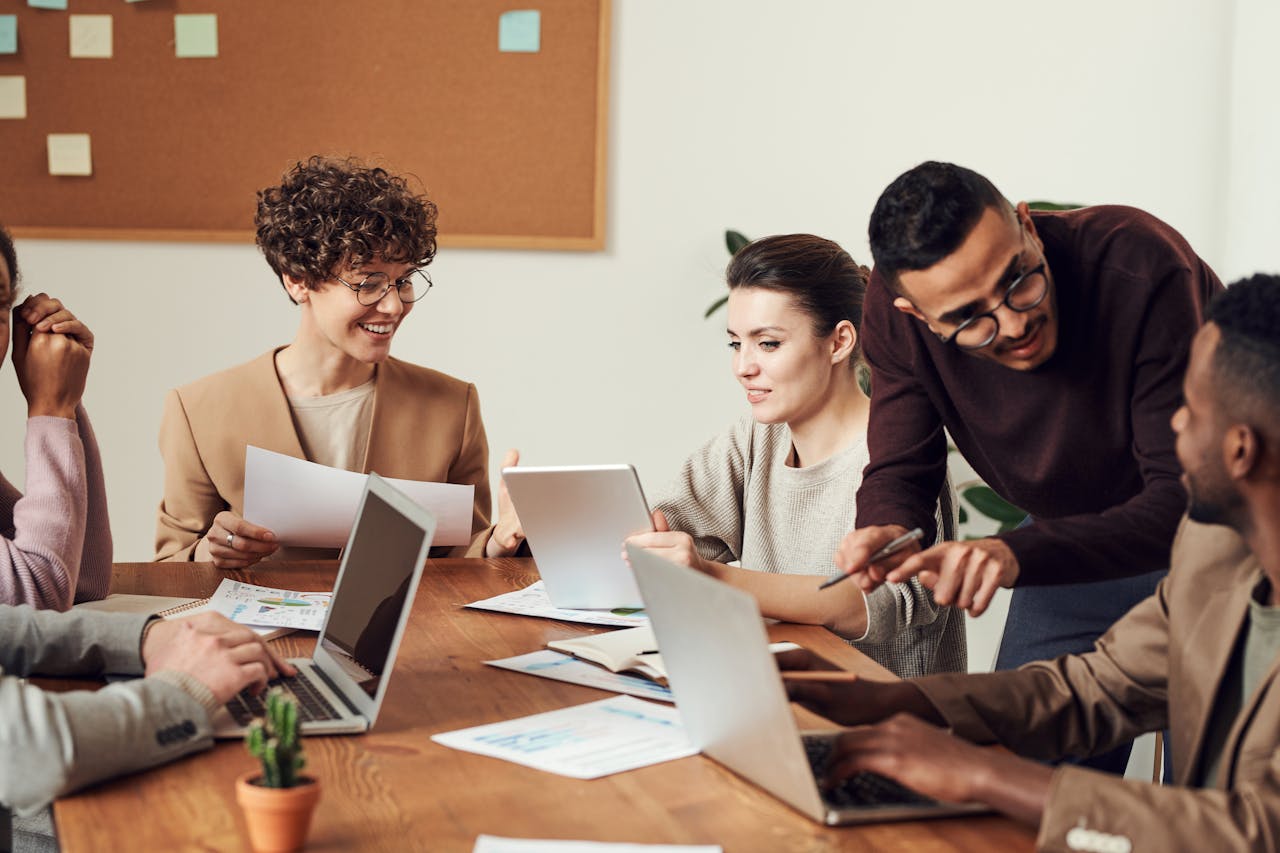 Crafting Captivating Headlines: Your awesome post title goes here A diverse group of professionals engaged in a collaborative office meeting, sharing ideas and discussing projects.
